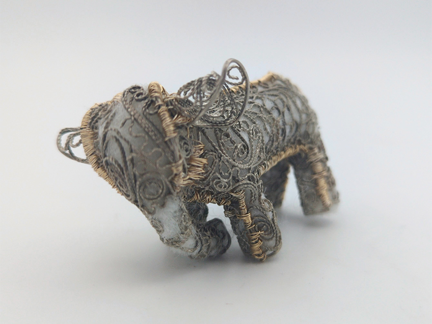 Hand-made stuffed animal elephant with scroll-decorated exoskeleton.