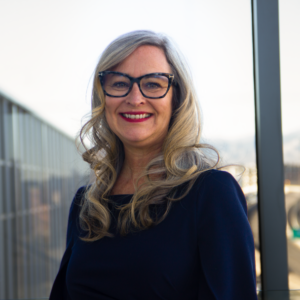 Woman wearing glasses and a dark blue dress
