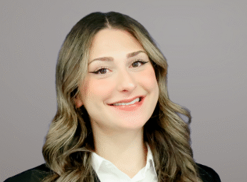 Kaden Henry, an MSU Denver student, poses for a head shot wearing a white blouse and black suit jacket.