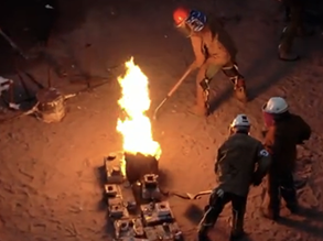 Students gather around molten metal at Iron Pour!