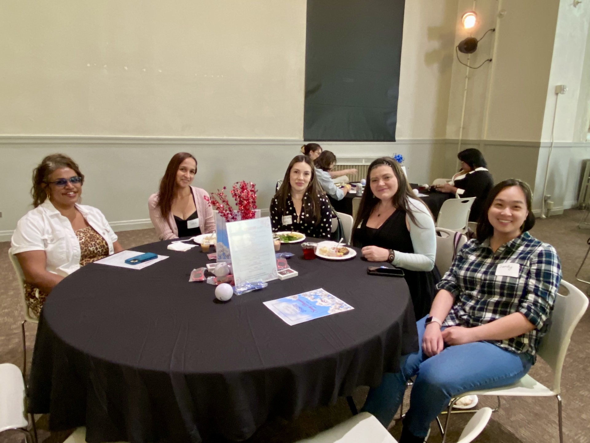 5 MPAcc students smiling at a table at the SP'26 ASO Spring Banquet