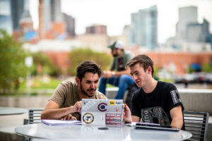 two students at an outdoor table studying