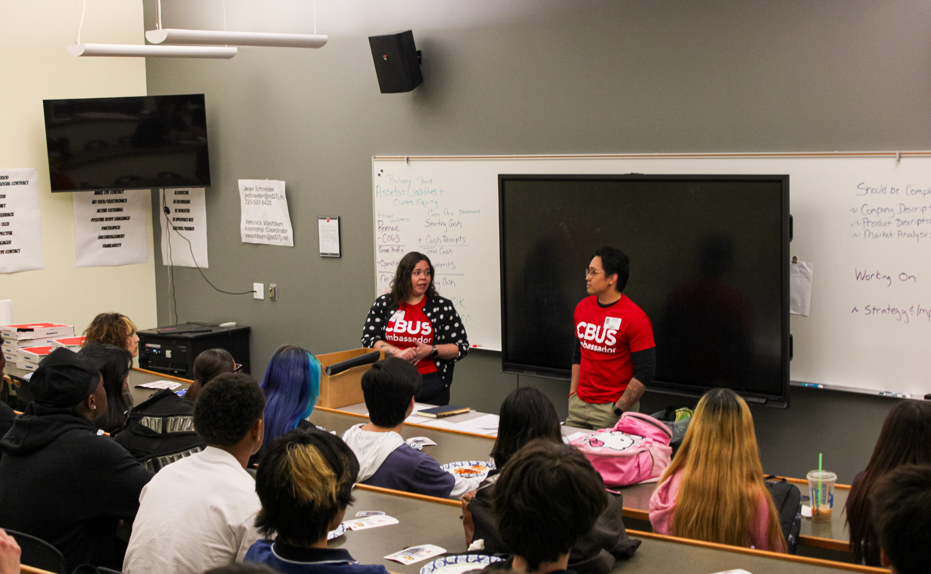 Two CBUS Student Ambassadors talking with a High School Class