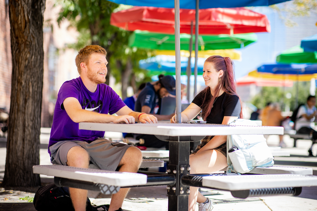 A colorful afternoon with two students talking
