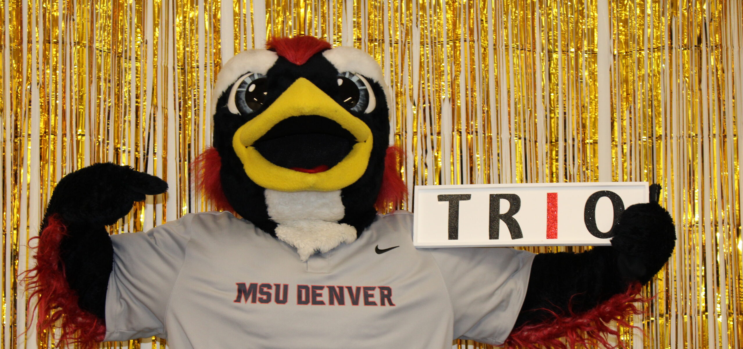 Rowdy the mascot holding a TRIO sign