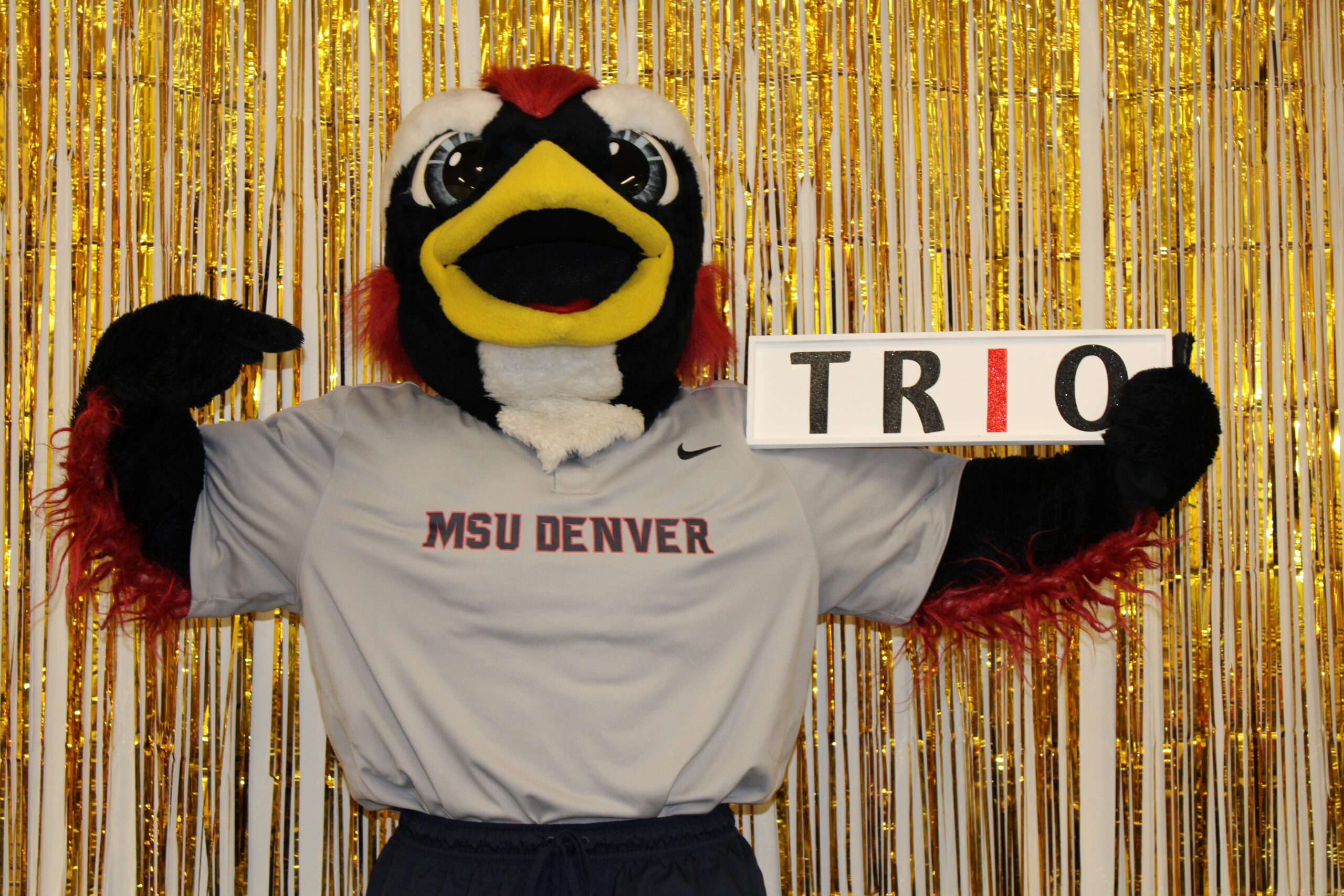 Rowdy the mascot holding a TRIO sign