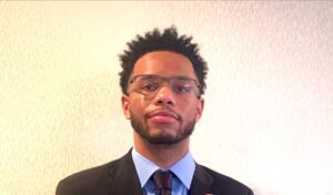 Male with glasses smiling