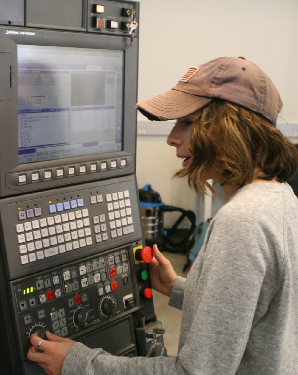 Advanced manufacturing student programming CNC machine