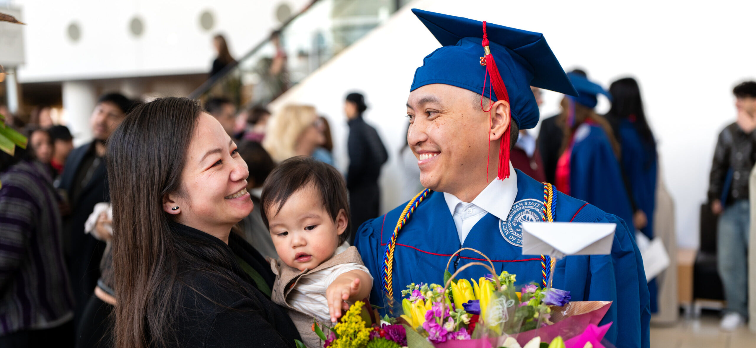 Families gather with graduates after commencement.