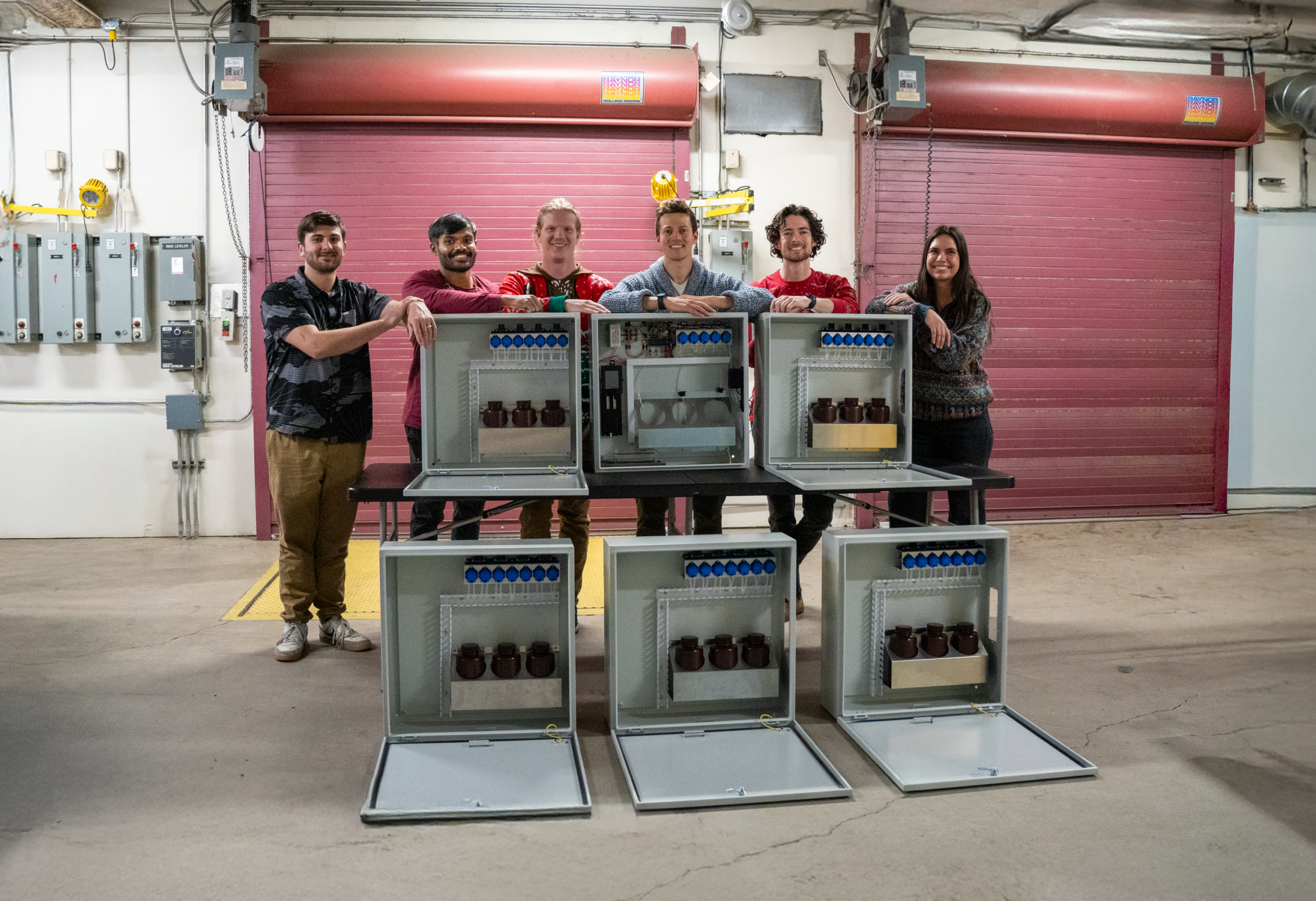 Six students posing with a science project