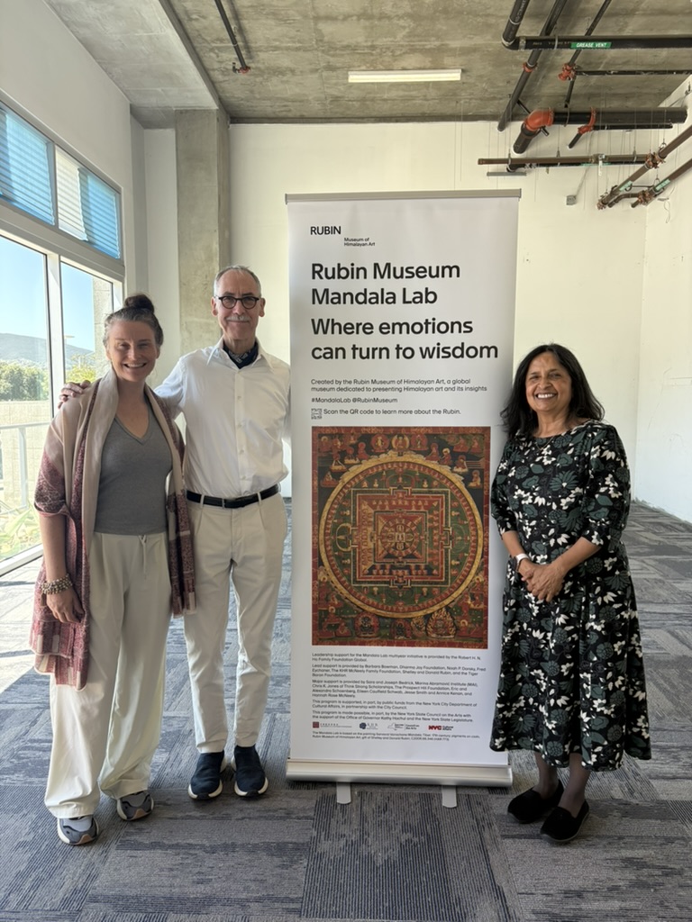 Dr. Jessica Rossi-Katz standing with colleagues with pop-up banner.