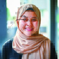 Woman smiles wearing a tan hijab