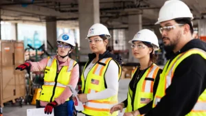 From left to right, Carolyn McGary, assistant professor and director of Construction Project Management in the Department of Engineering and Engineering Technology, chats with her students Kimberly DeSantiago and Casandra Chacon during the Summit House construction tour.