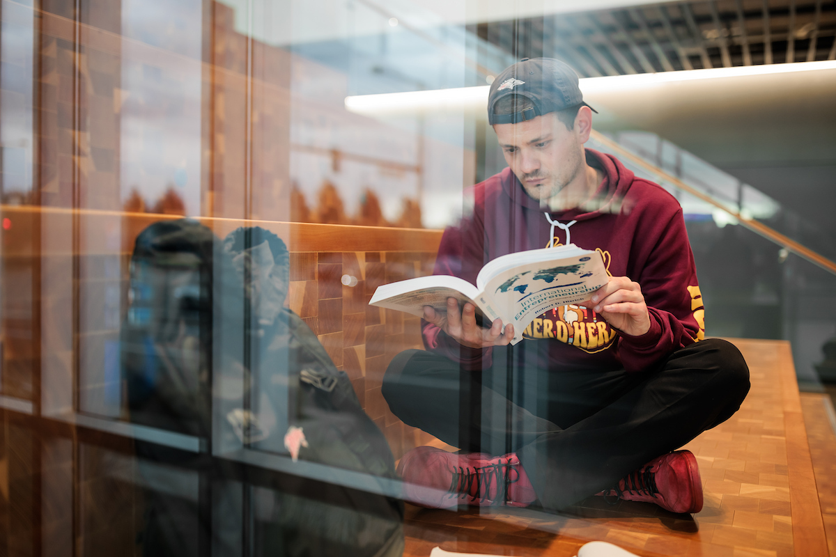Student studying being a window.
