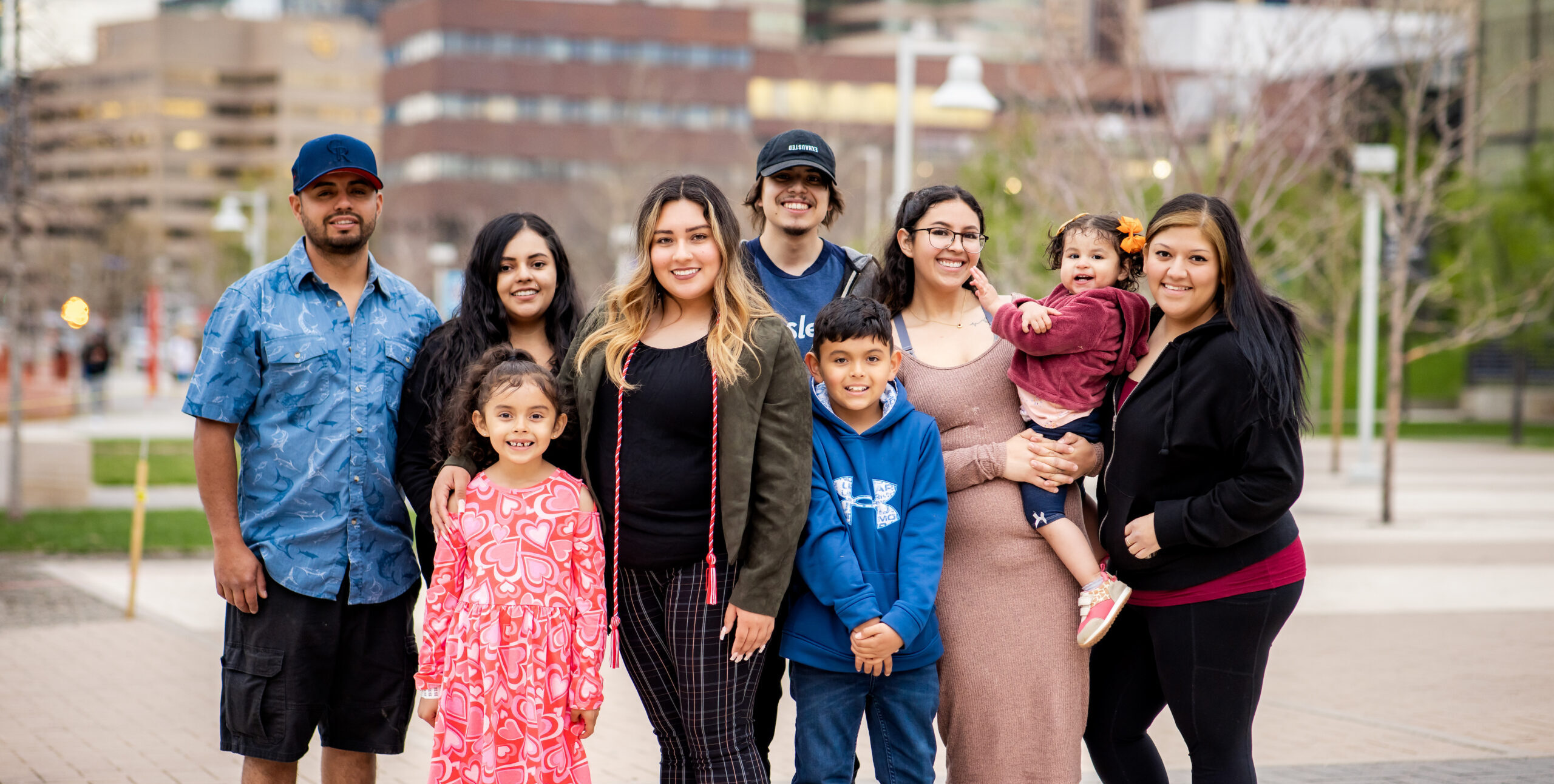 A first generation graduation family photo on the Auraria campus.