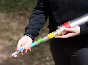 Claire Tiemann shows the tube they use to help with conducting research once a snake is found.
