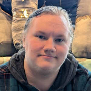 A person with blonde hair wearing a hoodie