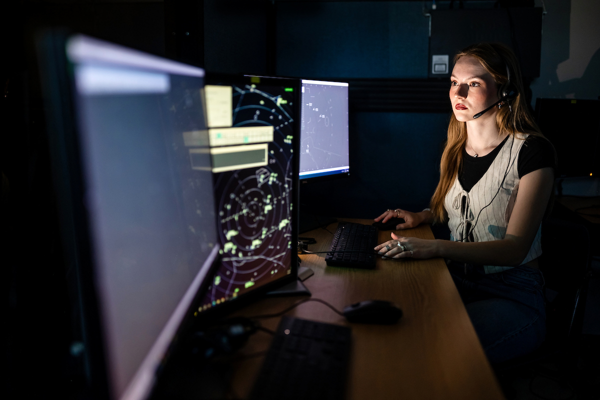 Student looks at a scope of air traffic.