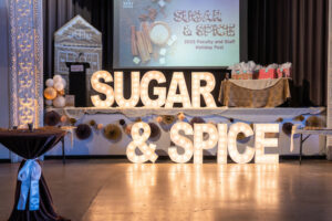 Marquee letters spell out 'Sugar & Spice' alongside some other on-theme decor on the Tivoli Turnhalle stage.
