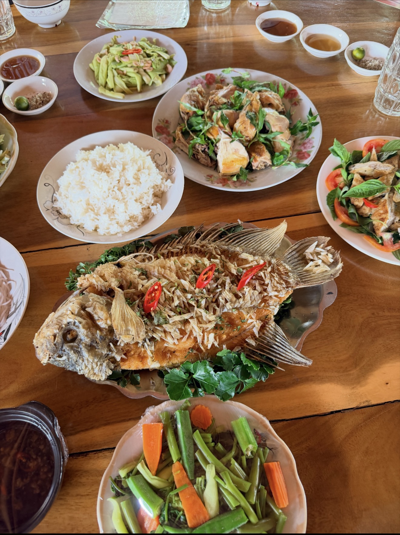 A picture of a fish, rice, and veggies.