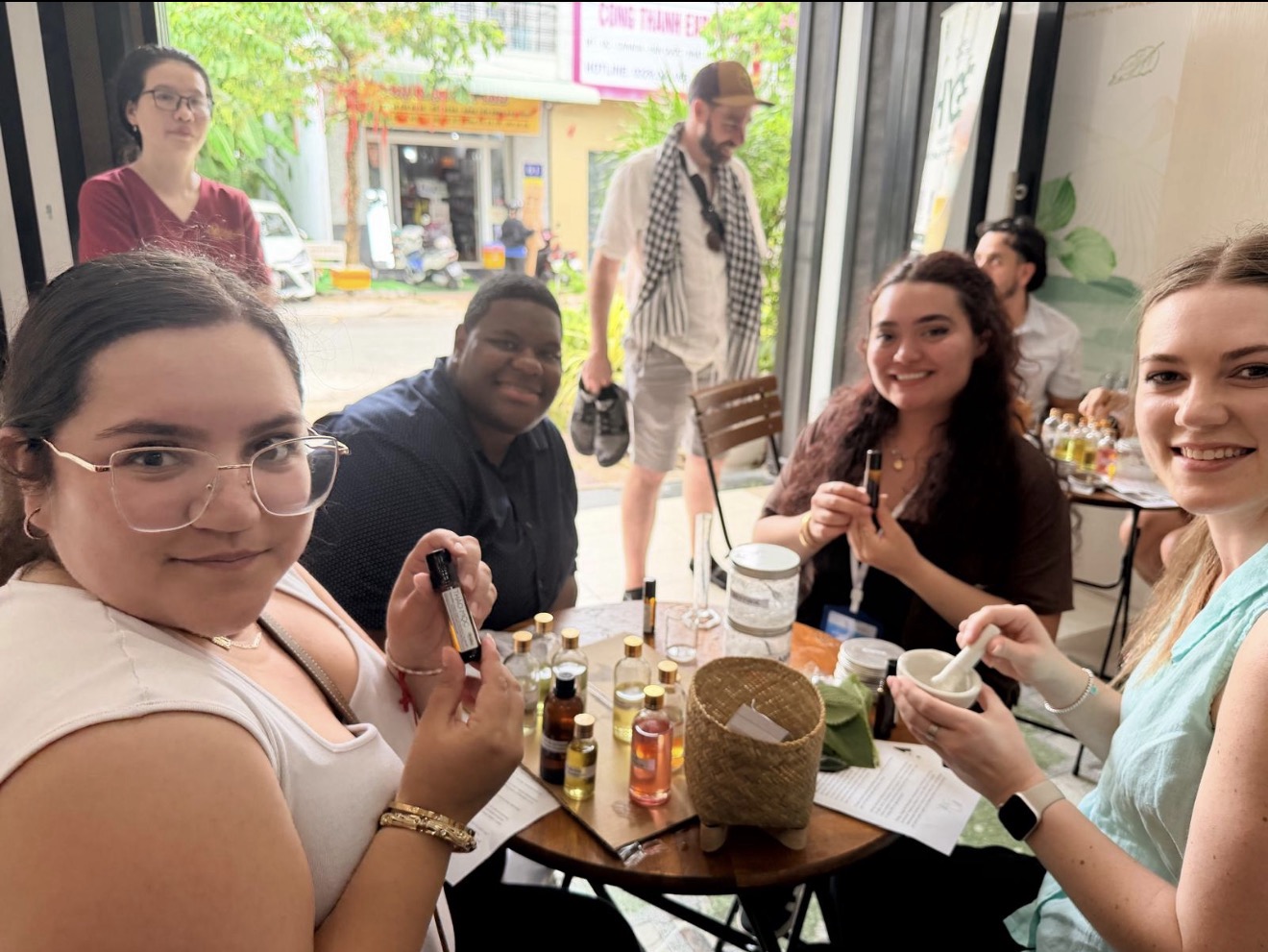 Selfie of four business students making essential oils in Vietnam.