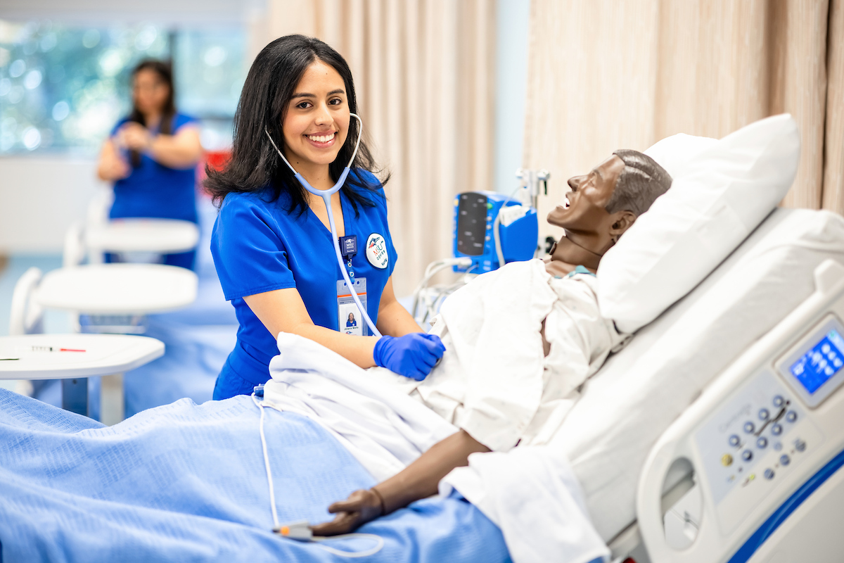 Nursing student listens to lung sounds.