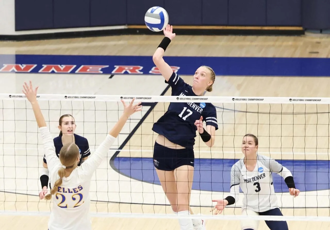 Student athlete on the volleyball court spiking a ball.