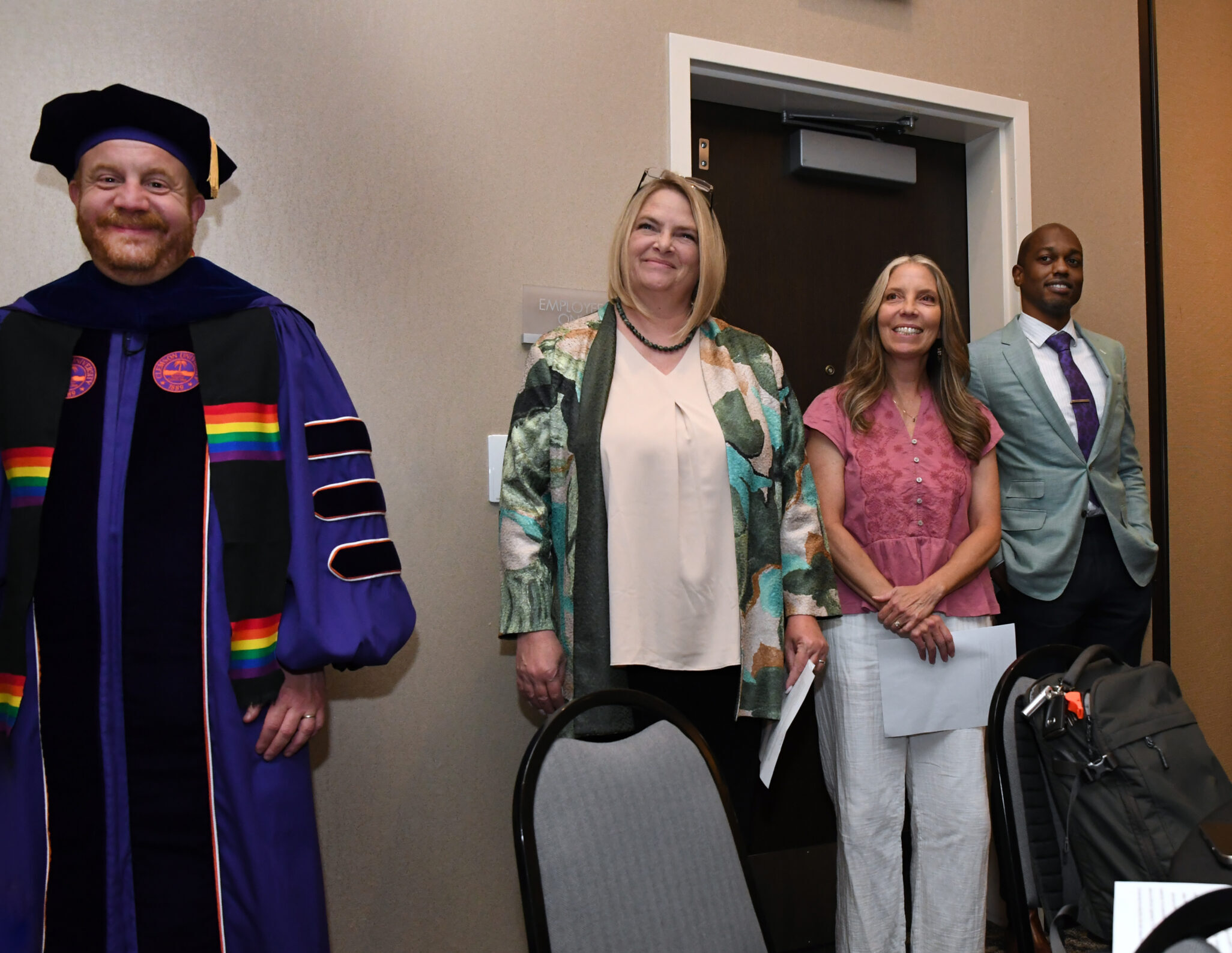 Assistant Dean, 3 faculty, and Vice Provost smiling in the audience of the SP '26 MBA & MPAcc Hooding Celebration