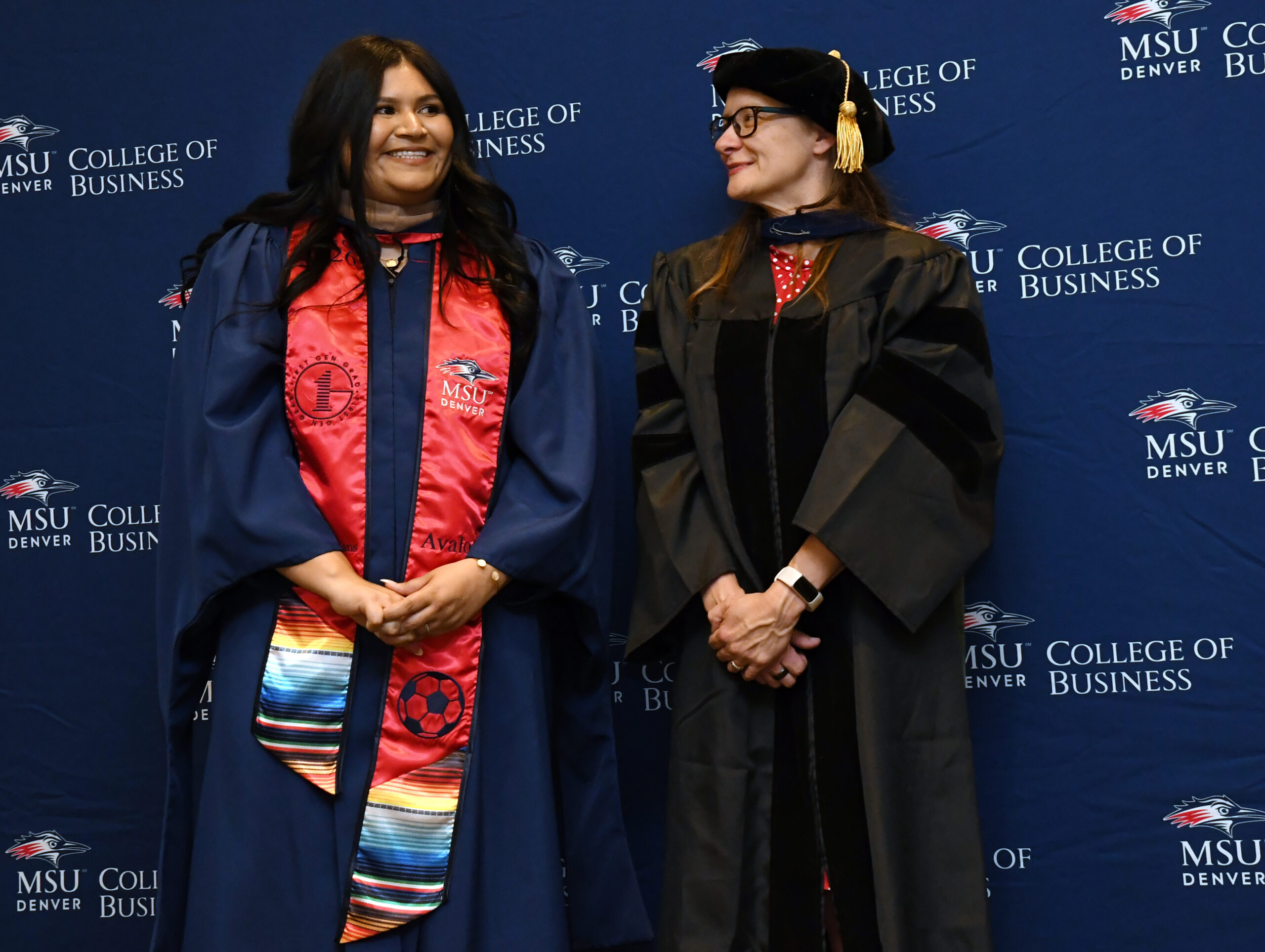 faculty, Letitia, after hooding MPAcc grad, Lilia, at SP'26 MBA & MPAcc Hooding Celebration