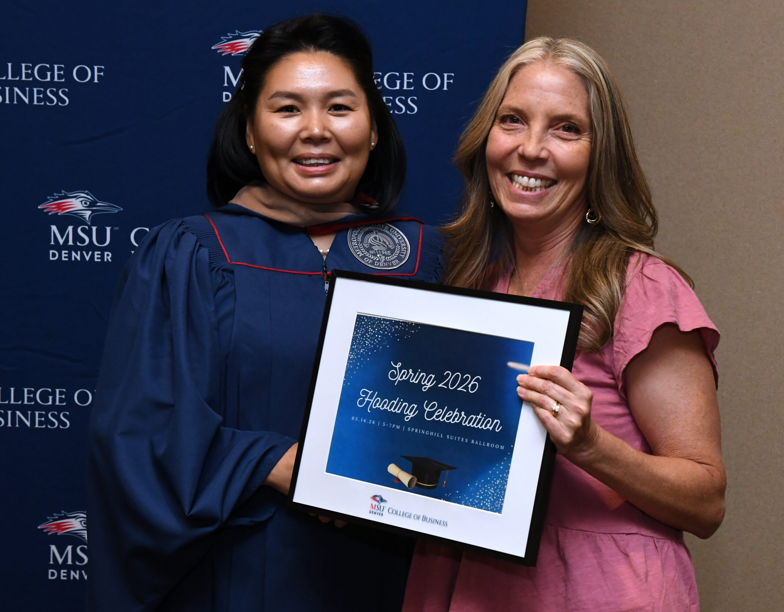 MPAcc grad, Otgontugs, and faculty, Amy, smiling at SP'26 MBA & MPAcc Hooding Celebration
