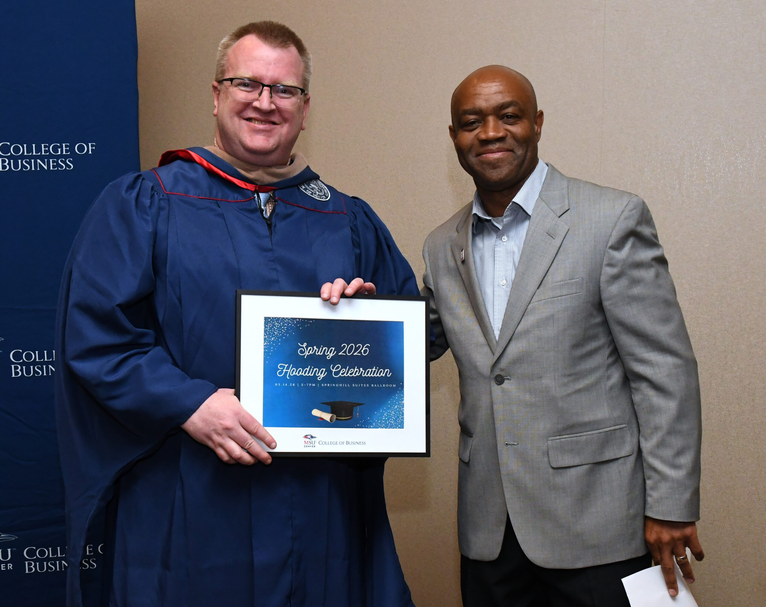 MPAcc grad, Tim, and Department Chair, Greg, smiling at SP'26 MBA & MPAcc Hooding Celebration