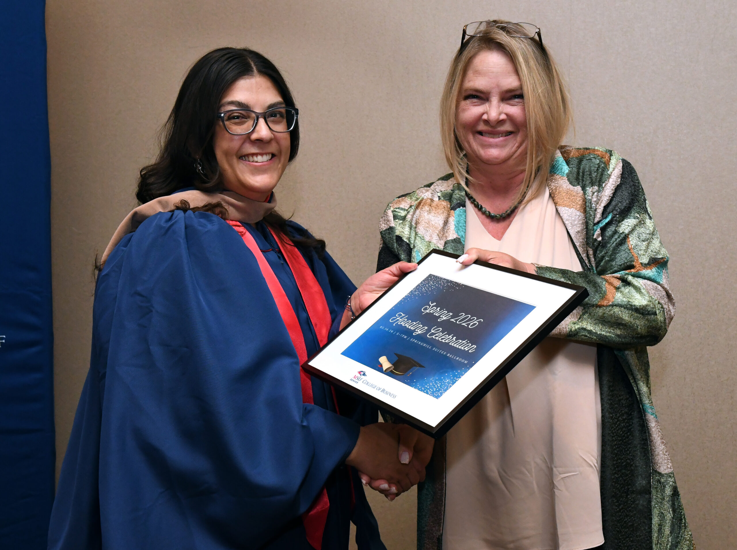 MPAcc grad, Kristina, and faculty, Kristina, smiling at SP'26 MBA & MPAcc Hooding Celebration