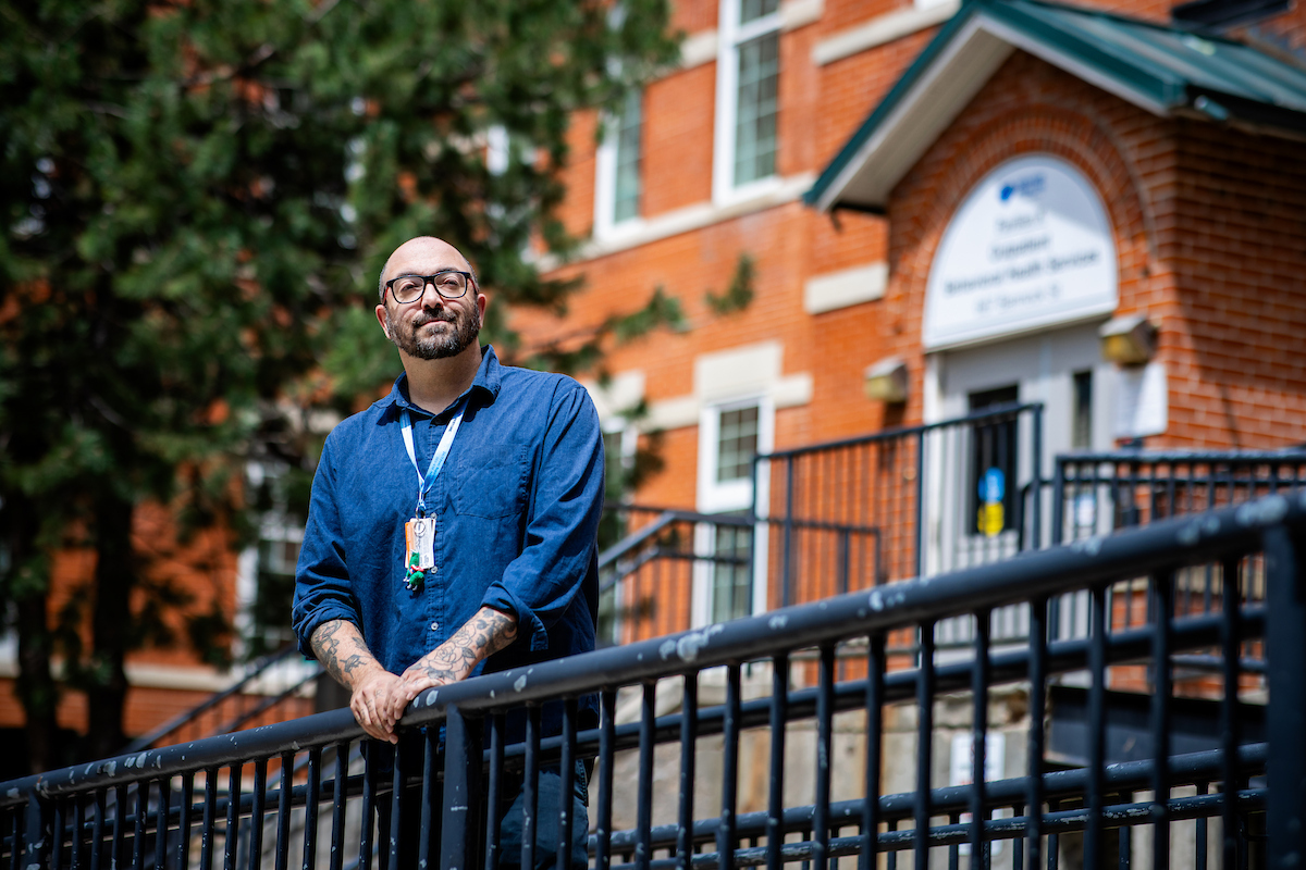 Student outside the Outpatient Behavioral Health Services building at the Denver Health campus.