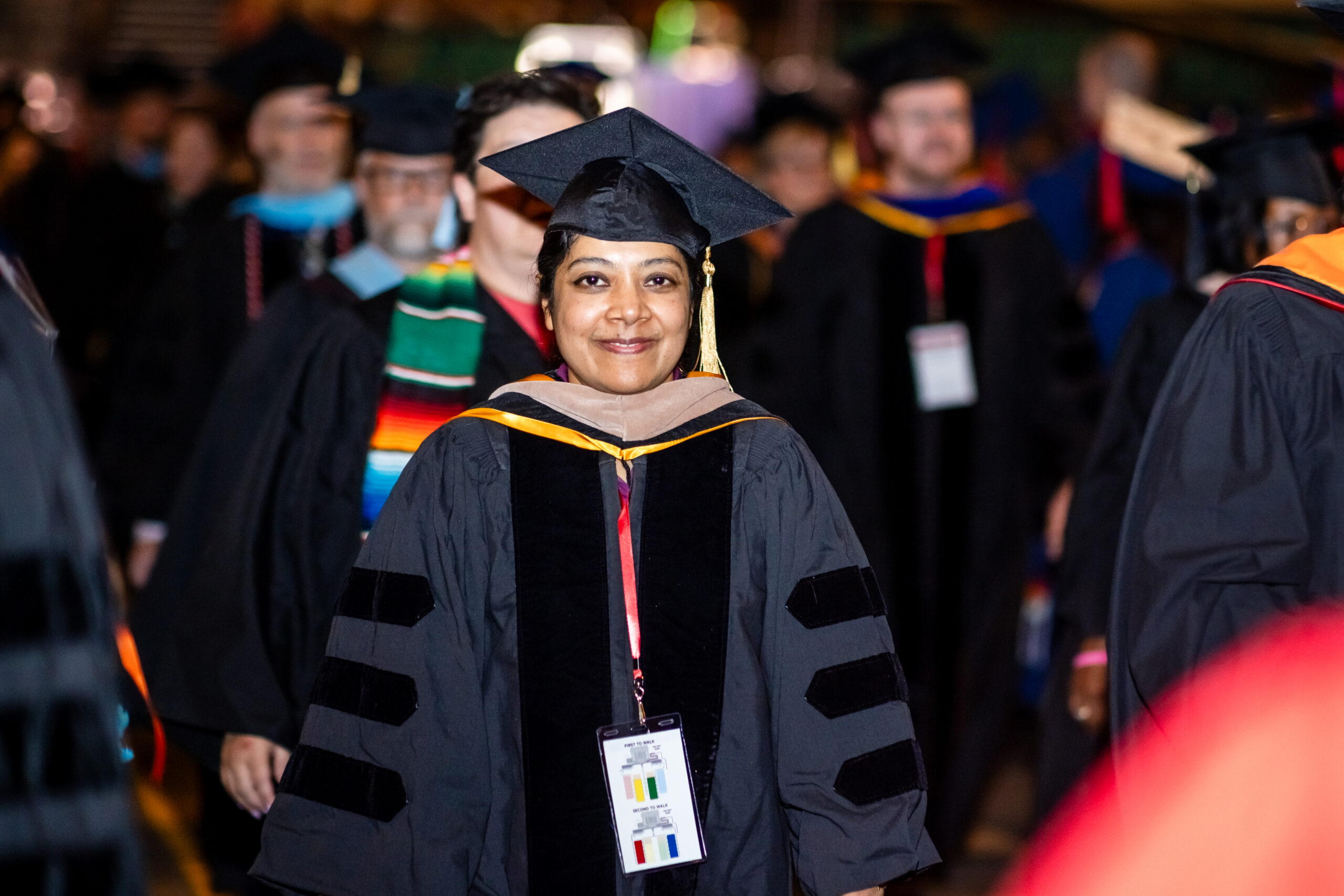 Accounting faculty, Salina, walks into the university’s morning commencement ceremony on May 15, 2026 in regalia.