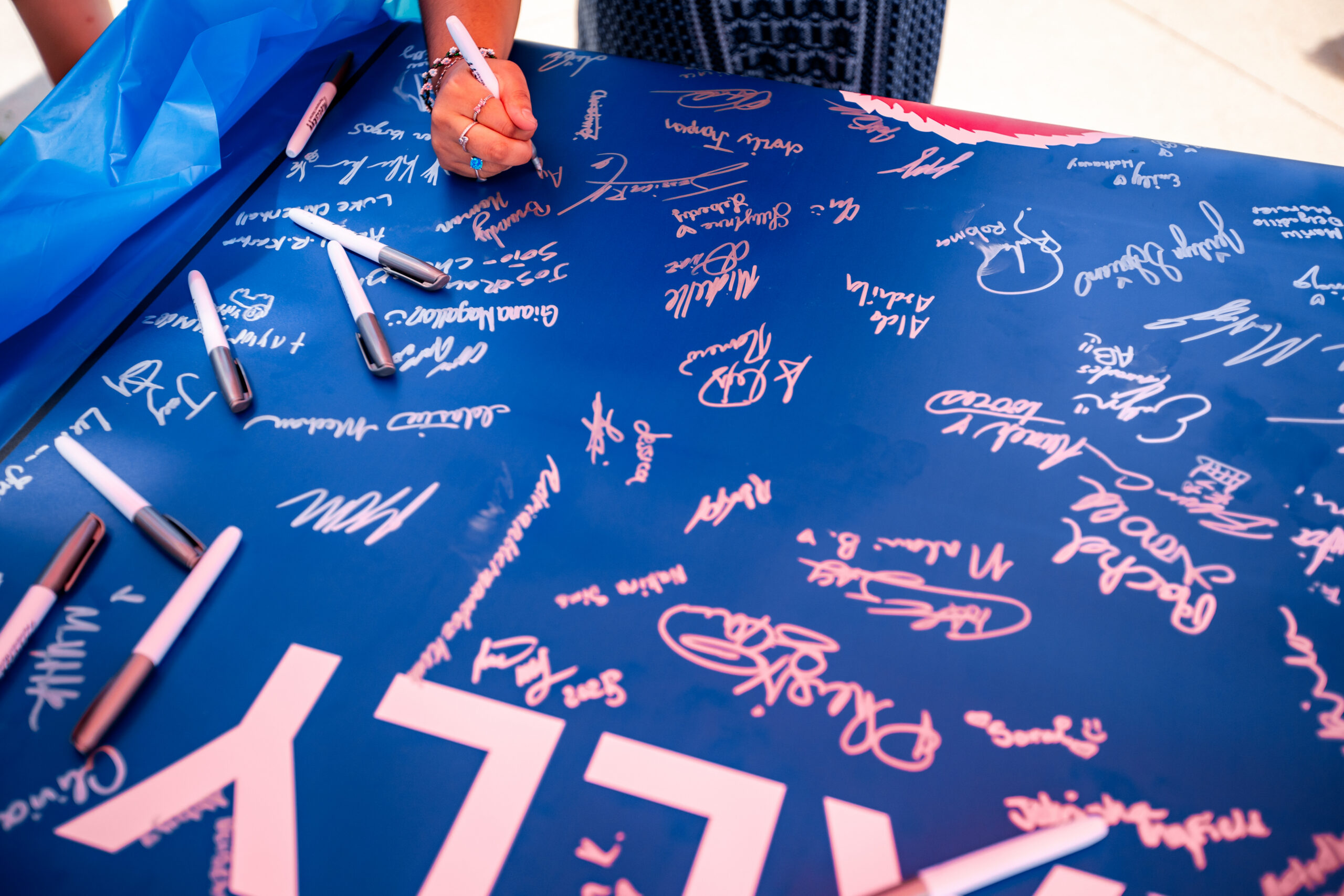 Convocation - students signing large banner