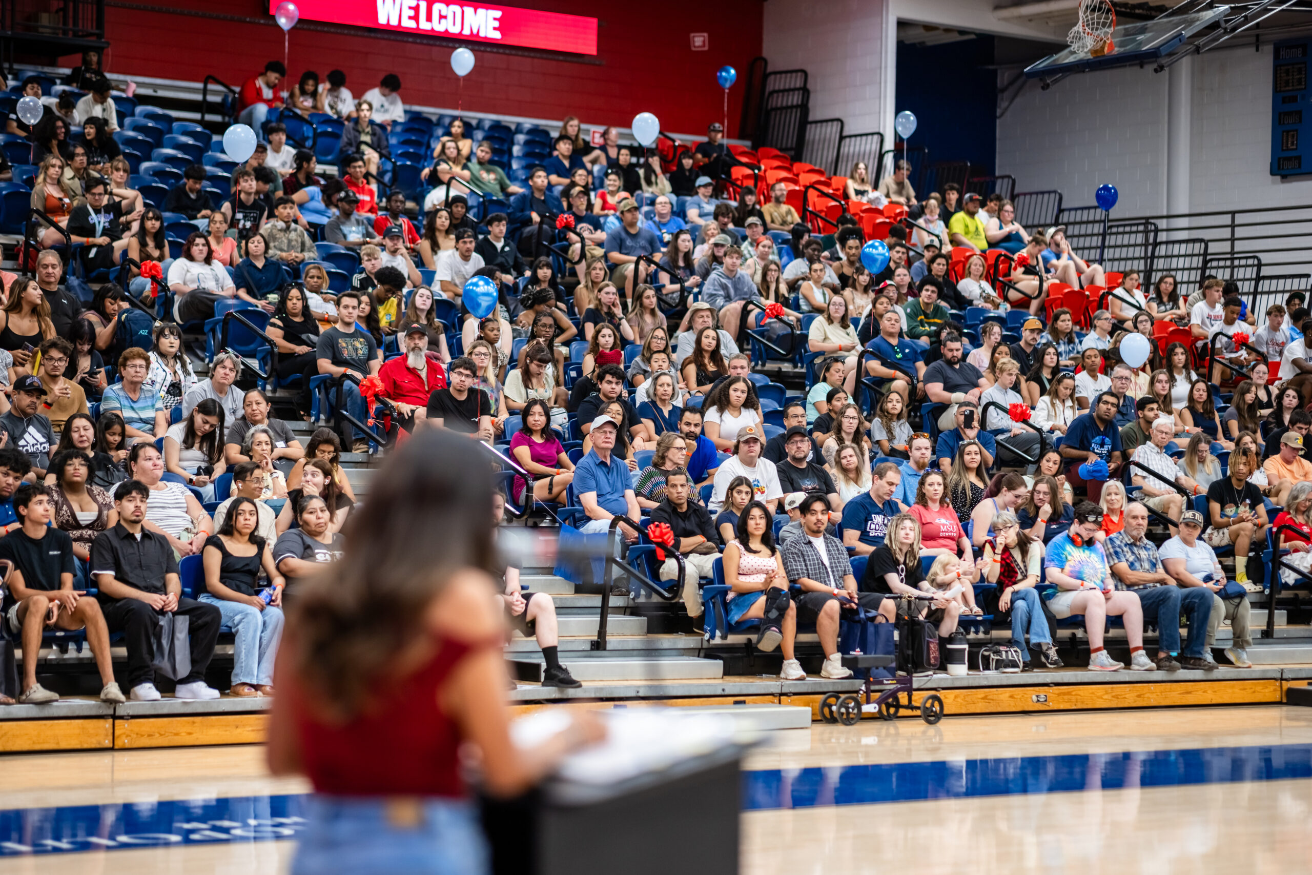 Convocation - speaker in foreground addressing audience in bleachers