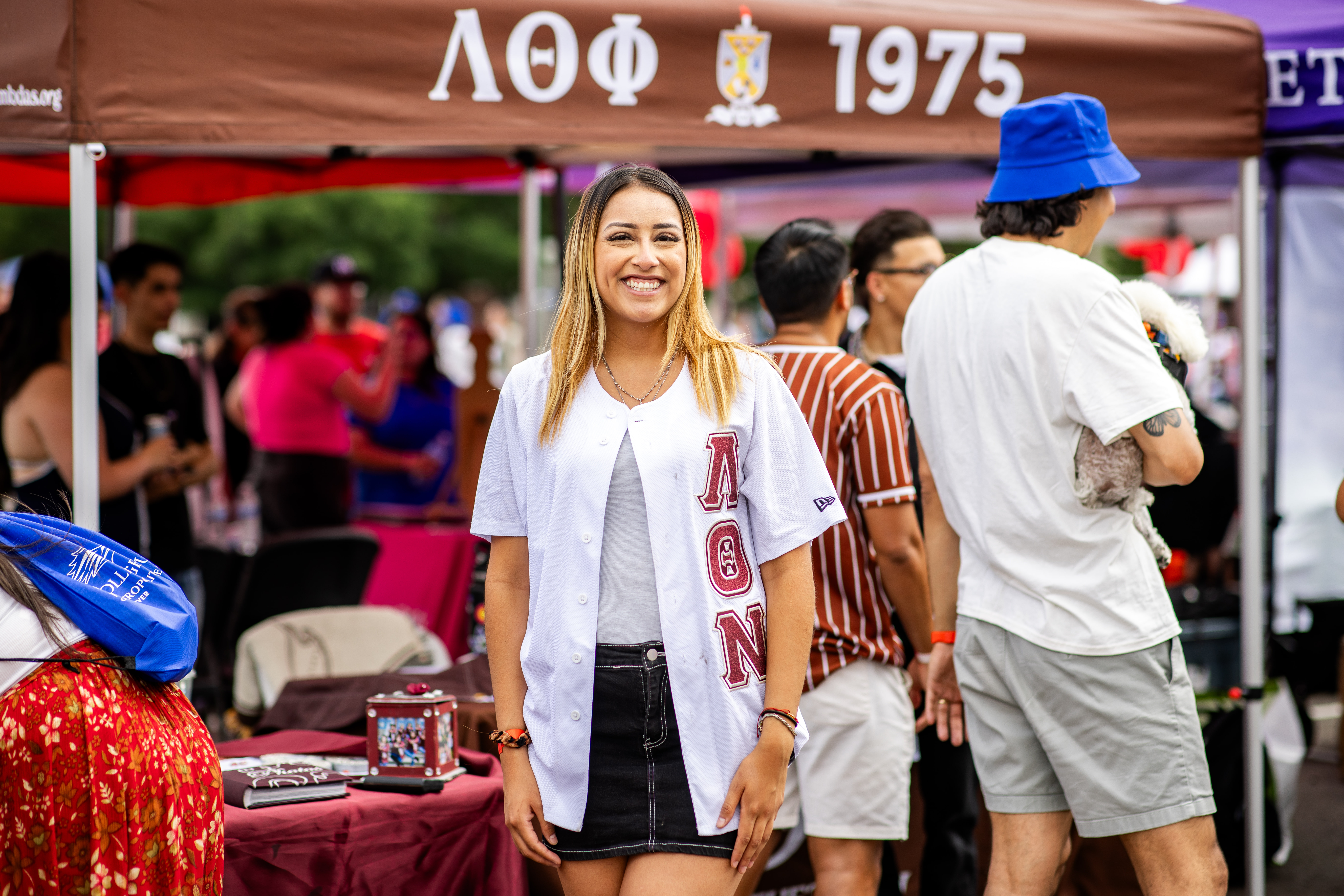 Convocation - sorority member in front of their booth