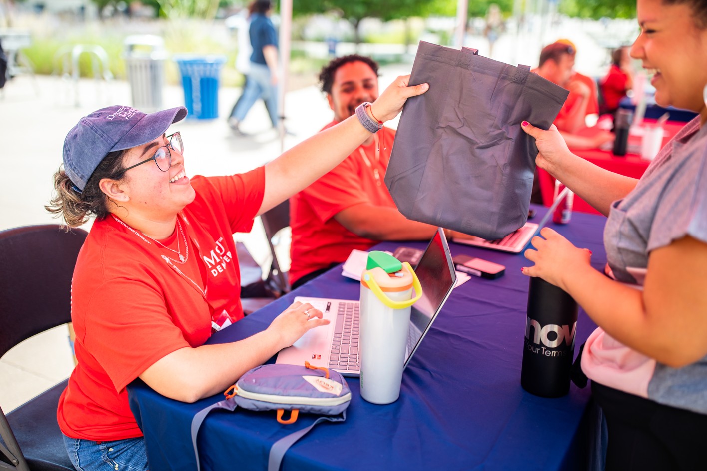 Student receiving swag bag at Rowdy Rally check-in