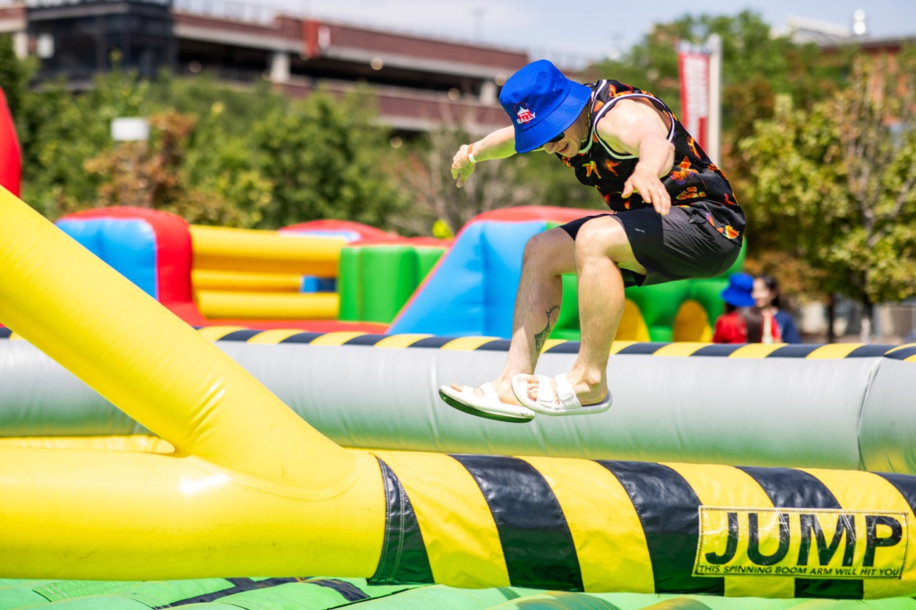 Student jumping a moving bouncy obstacle
