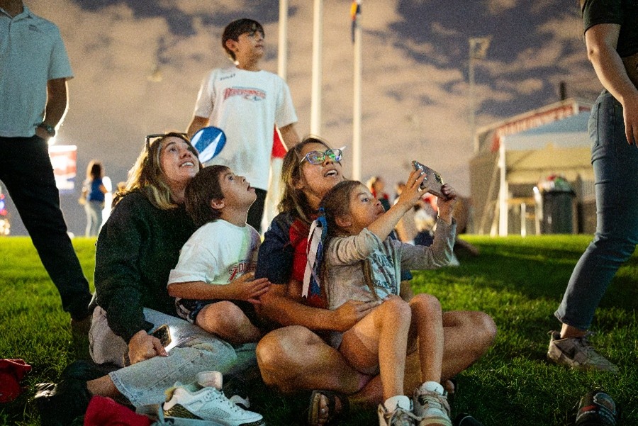 Students and children viewing cloudy skies