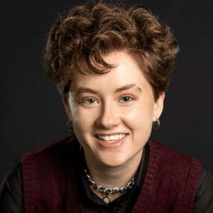 A person with short curly brown hair