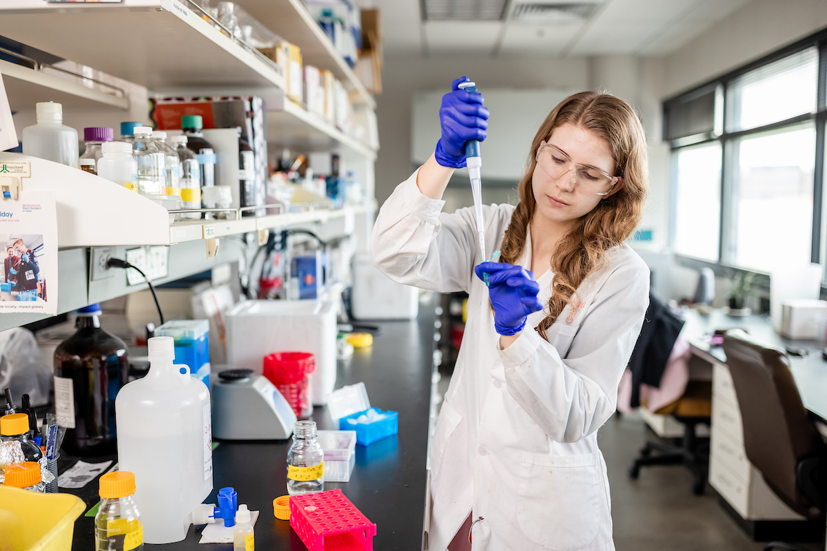 Student pipetting TCEP solution into DNA aptamer for testing purposes.