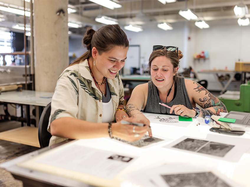 Two students working together on the light table.