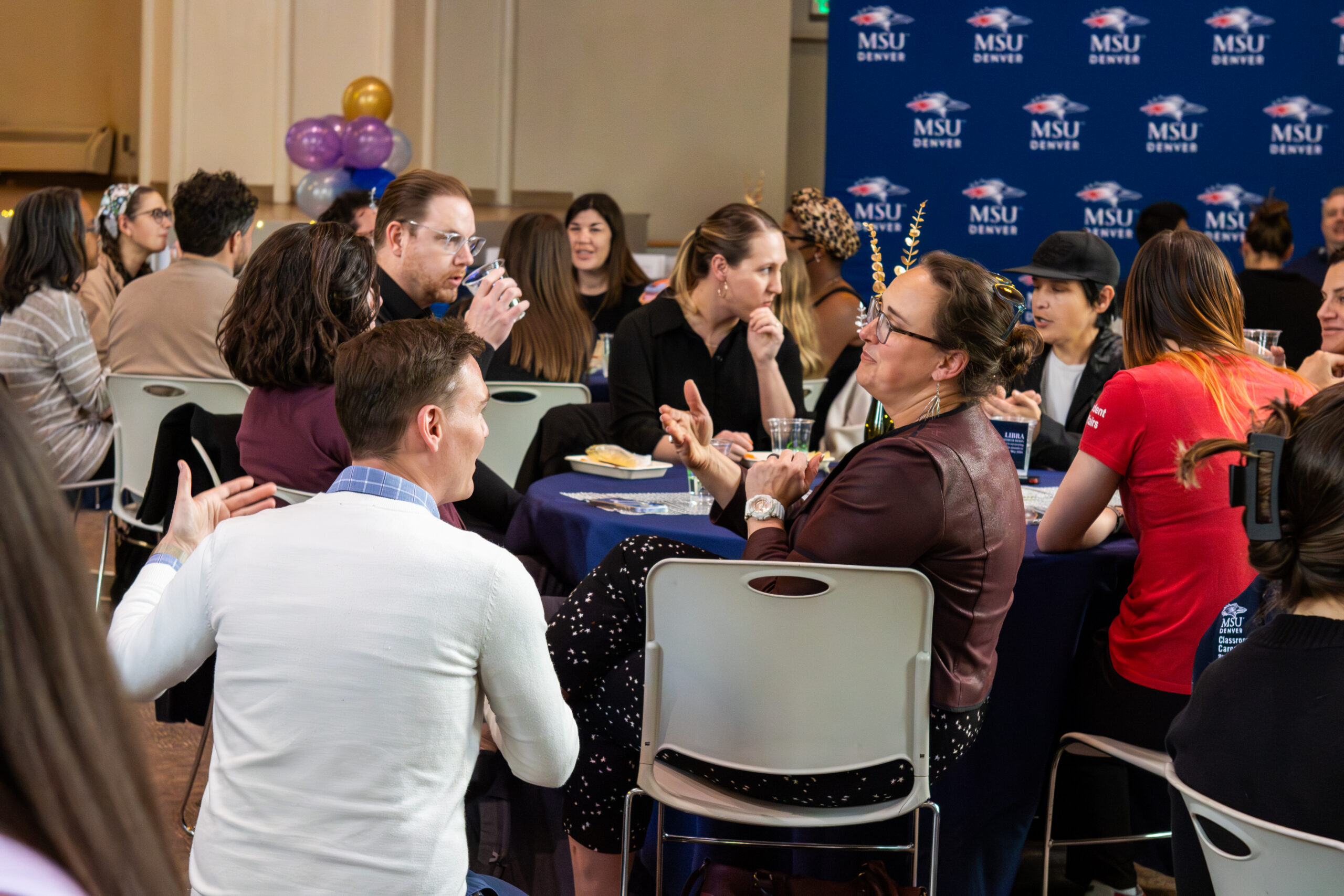 MSU Denver employees gathered around a table.