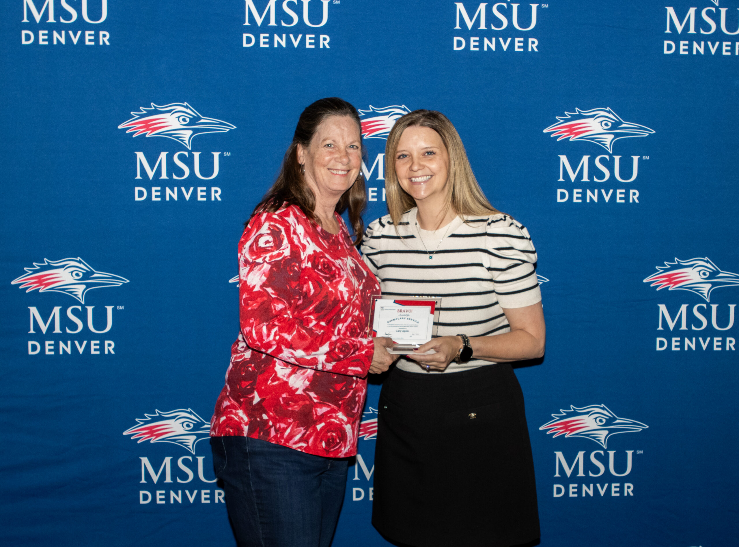 A photo of award winner with their award.