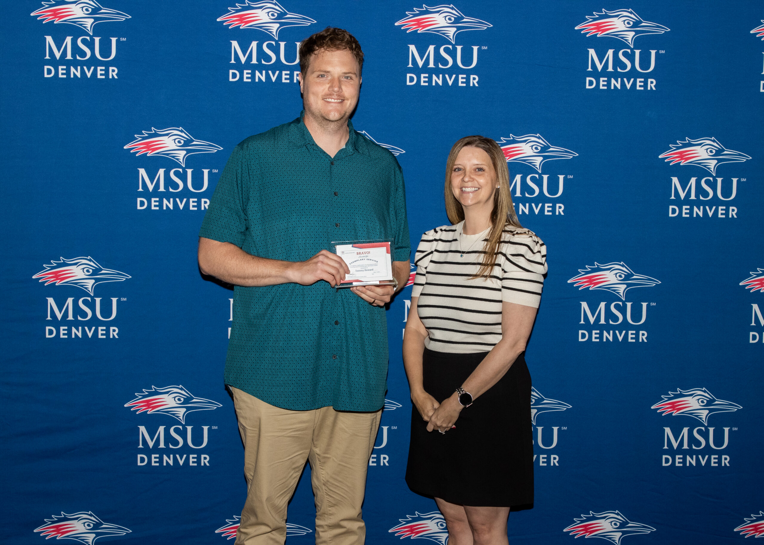 A photo of award winner with their award.