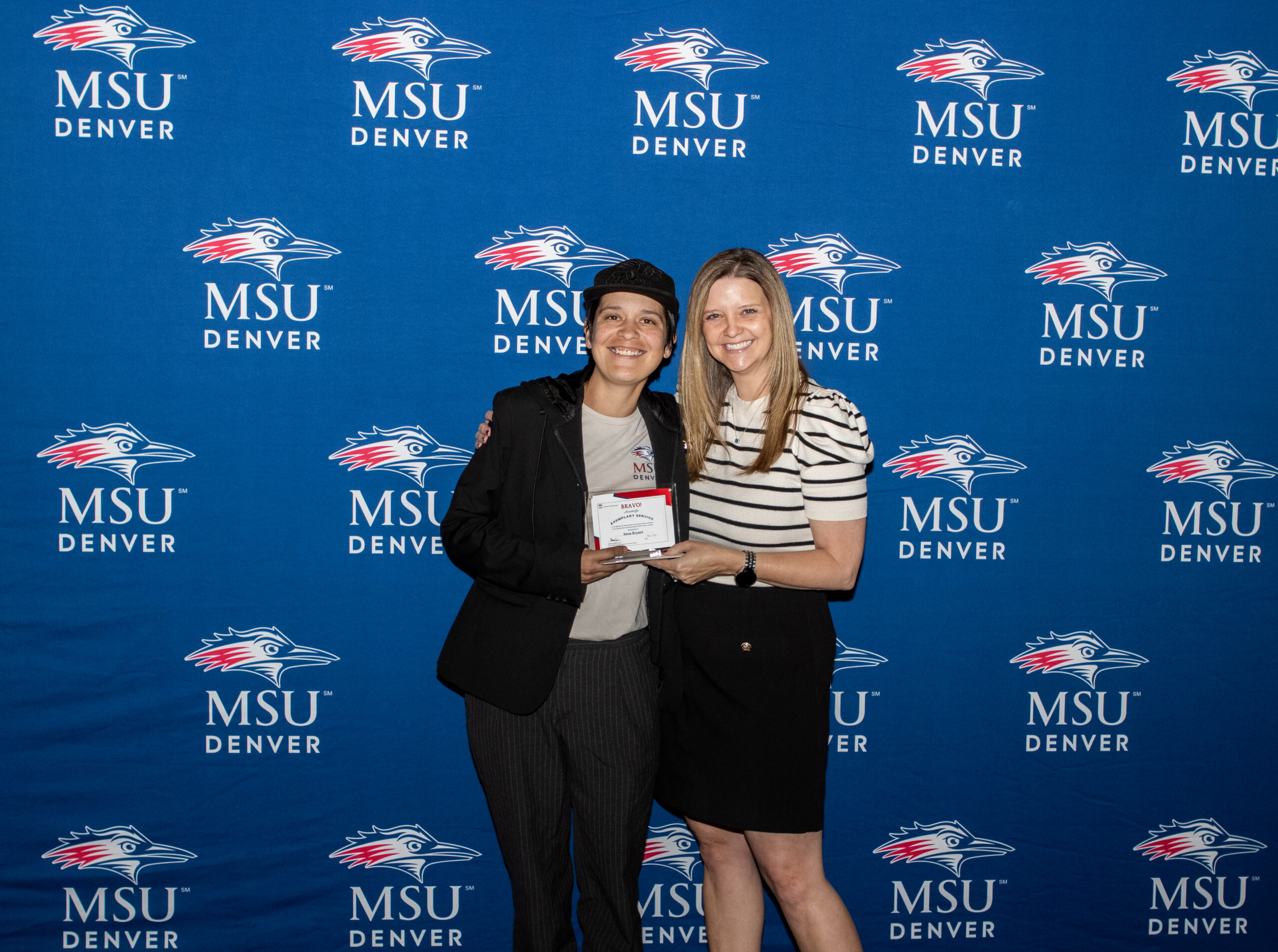 A photo of award winner with their award.