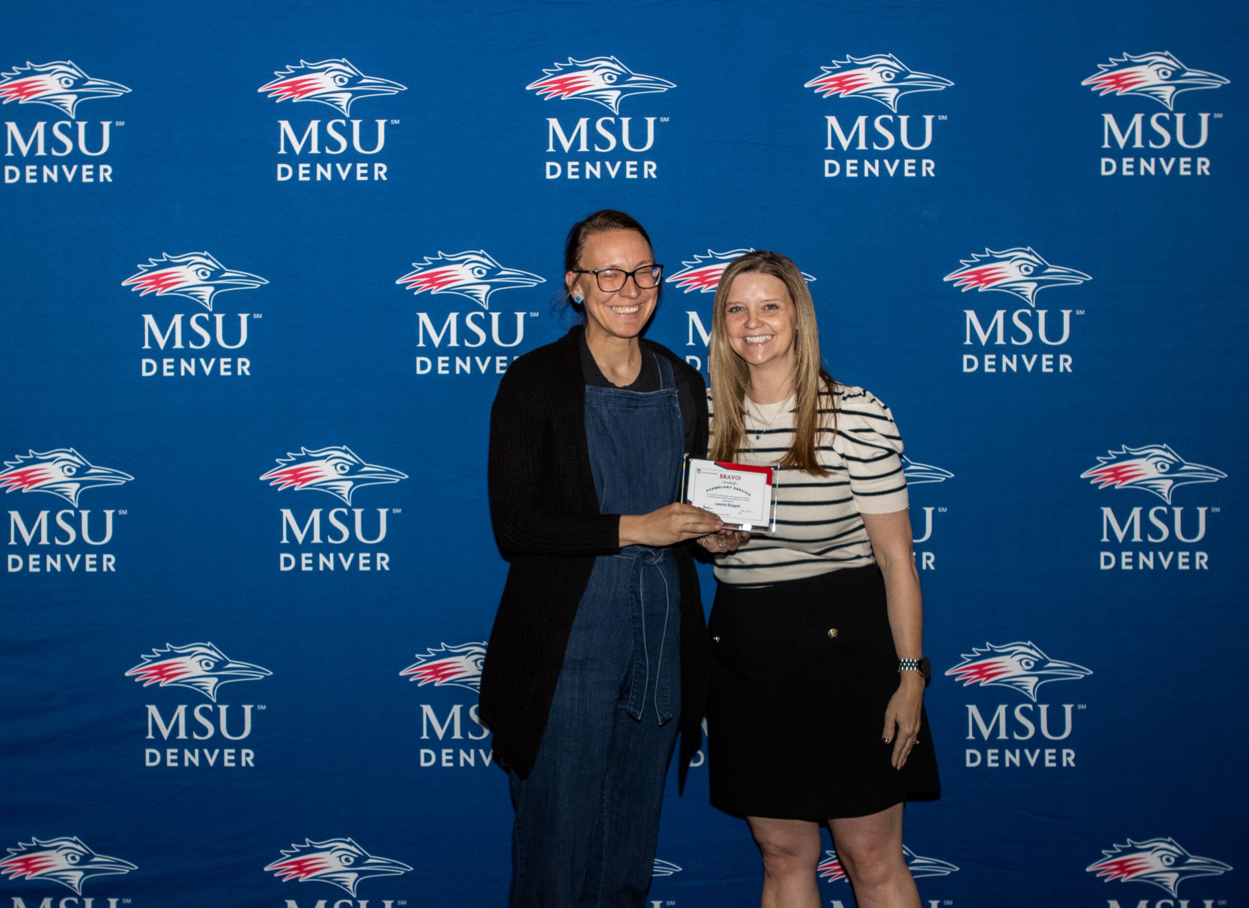 A photo of award winner with their award.