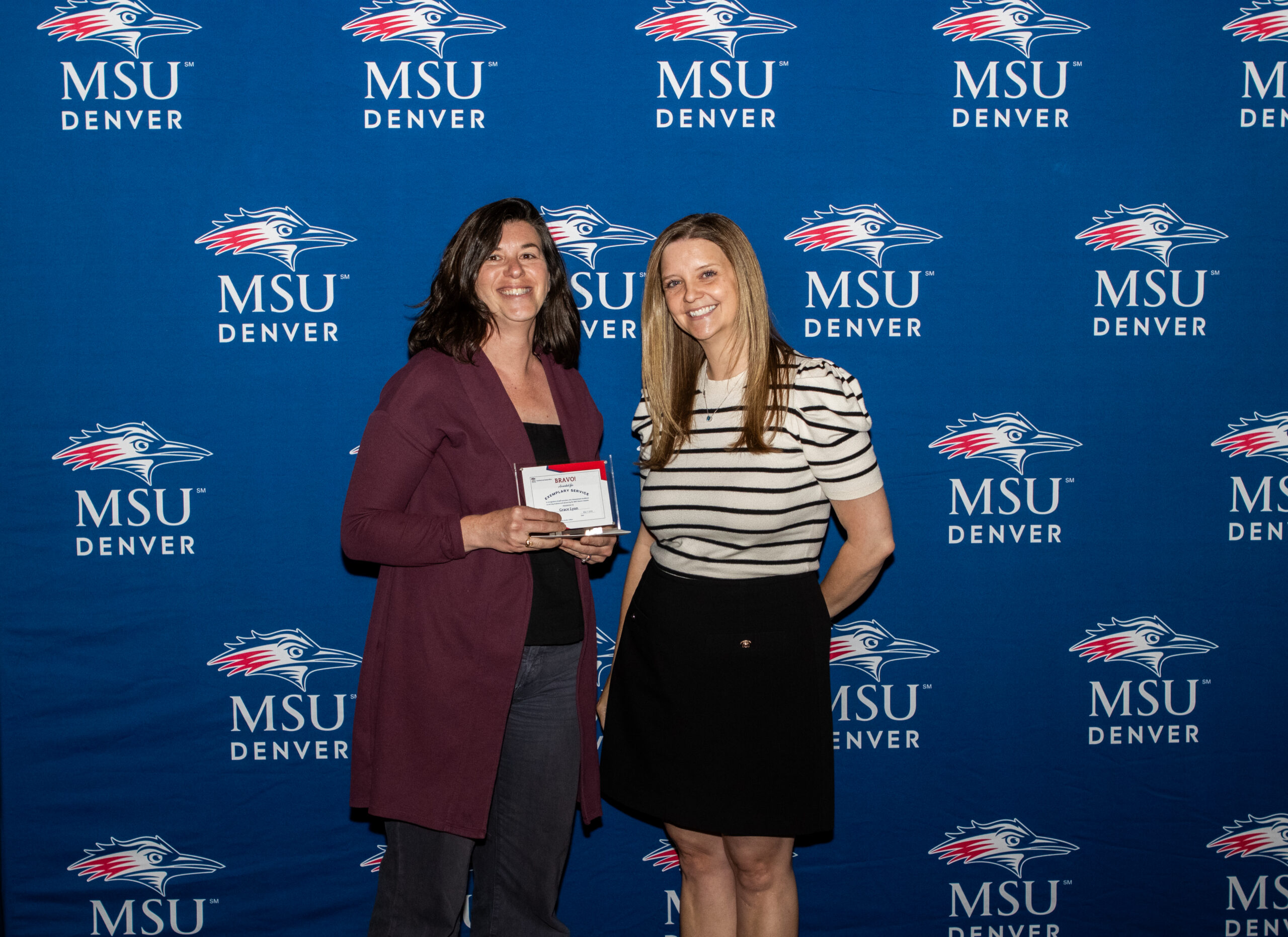 A photo of award winner with their award.