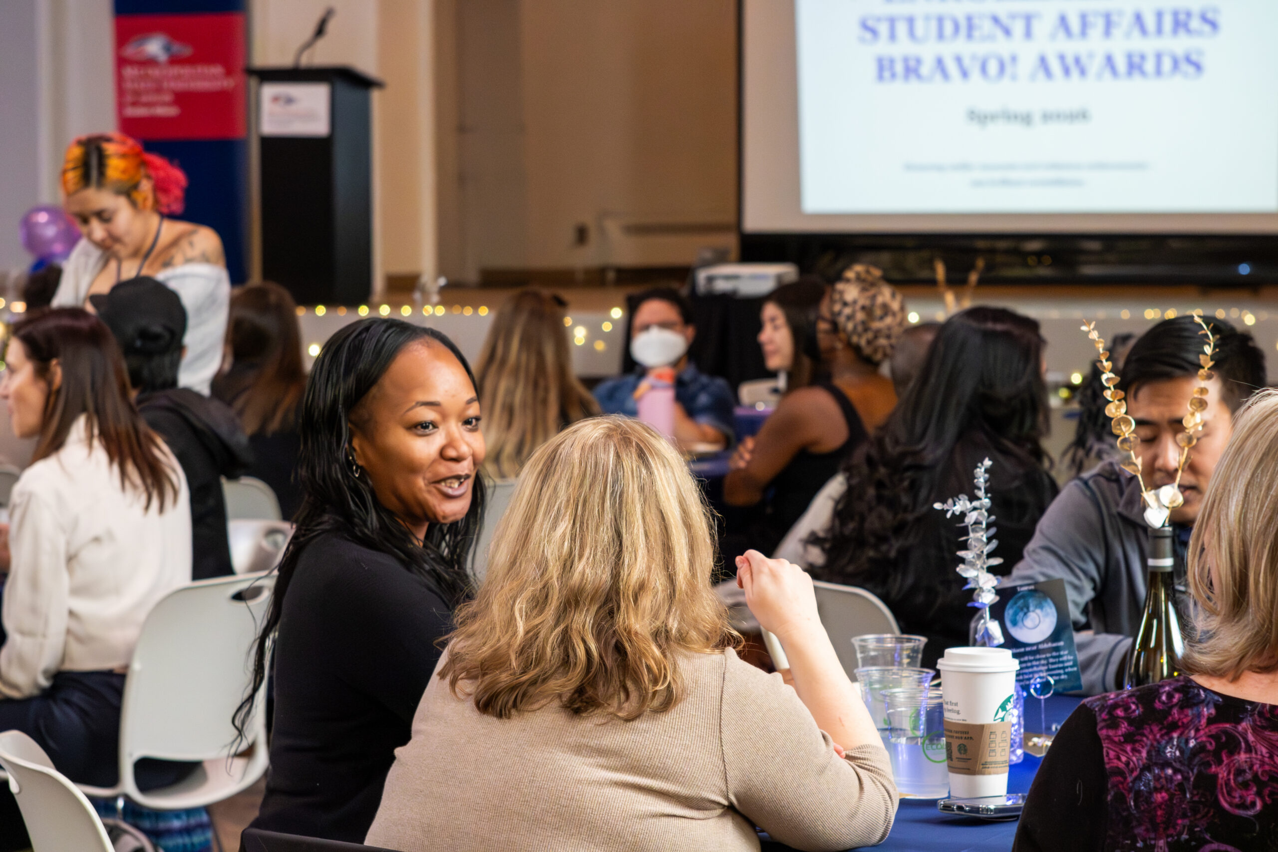 MSU Denver employees talking at different tables.